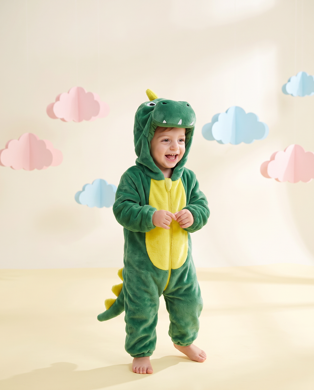 Toddler giggling in the ZipRoar Green Dragon hooded costume